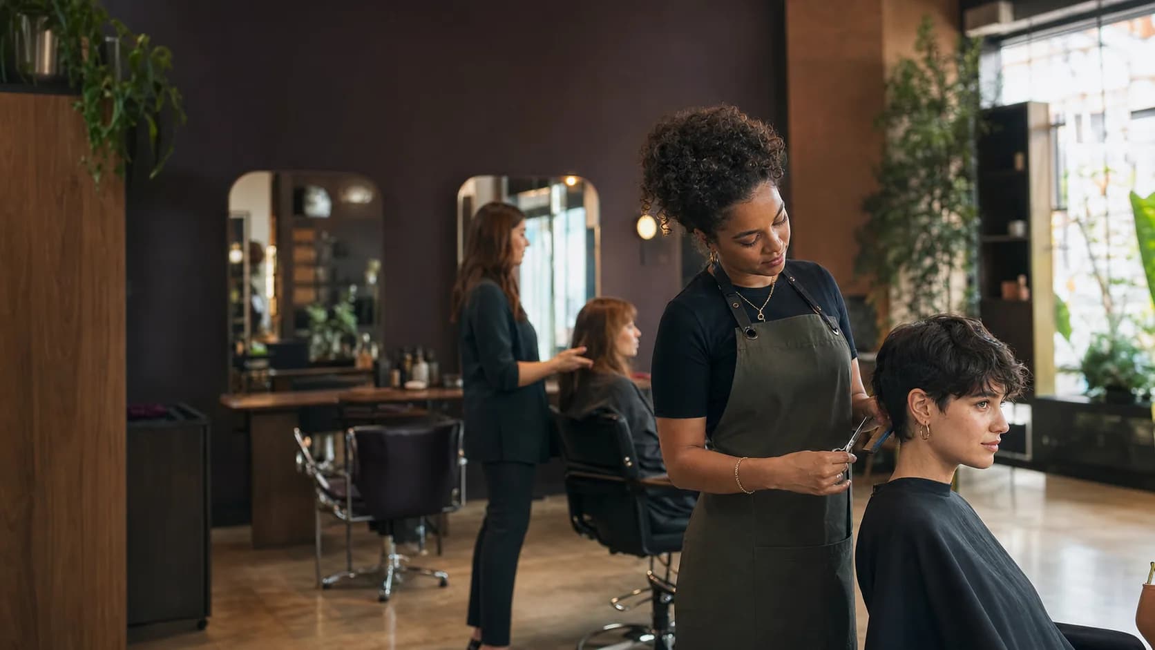 Hair salon professionals coordinating appointments and client care